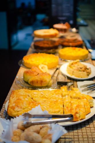 a table topped with different types of food on plates at Pousada e Hostel Chez Marianne in Salvador
