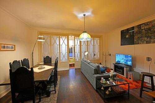 a living room with a couch and a table at Matriz Guest House in Portel