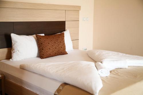 two beds with white sheets and pillows in a room at S Club Resort Hotel Aqua Park and Spa in Belgrade