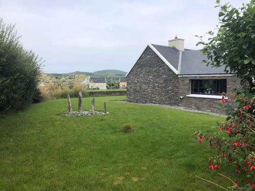 a stone house with a yard in front of it at Skellig View in Portmagee
