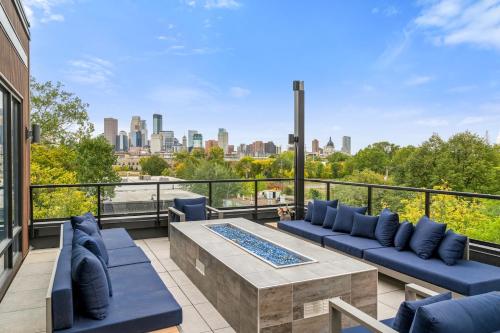 a balcony with blue couches and a view of the city at Kasa Bryn Mawr Minneapolis in Minneapolis
