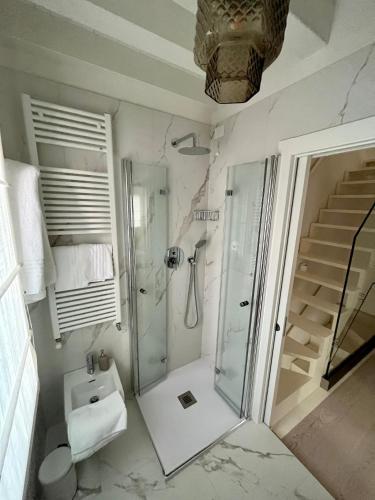 a bathroom with a shower and a toilet and a sink at Alla Torre 735 - Stay Local Burano in Burano