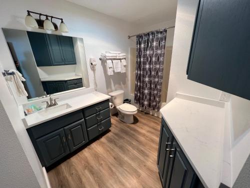 a bathroom with a sink and a toilet and a mirror at Arch Canyon Inn in Blanding