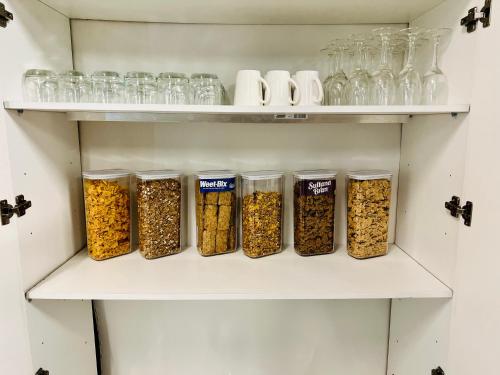 a pantry with four jars of food on shelves at Avoca Motel in Avoca