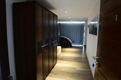 a hallway with wooden doors and a hallway with a room at Ten30 Hikkaduwa in Hikkaduwa