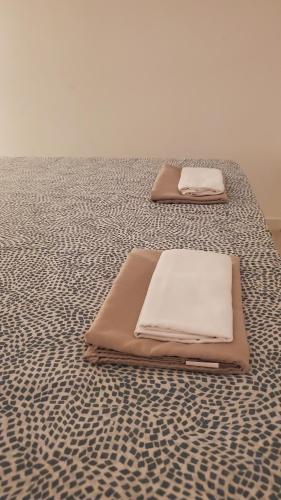 two beds are sitting on top of a bed at B&B Lido Apartament 10B in Civitanova Marche