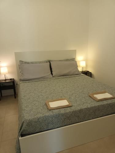 a bedroom with a bed with two plates on it at B&B Lido Apartament 10B in Civitanova Marche