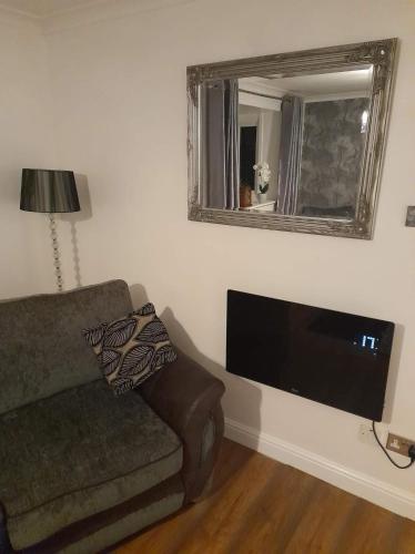 a living room with a couch and a flat screen tv at Hardwick Haven, Sedgefield - Near Hardwick Hall in Stockton-on-Tees