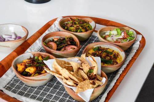 a tray of bowls of food on a table at Ten30 Hikkaduwa in Hikkaduwa