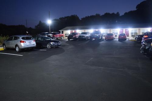 a parking lot with cars parked in front of a building at White Oaks Motel Pennsville/Carneys Point in Pennsville