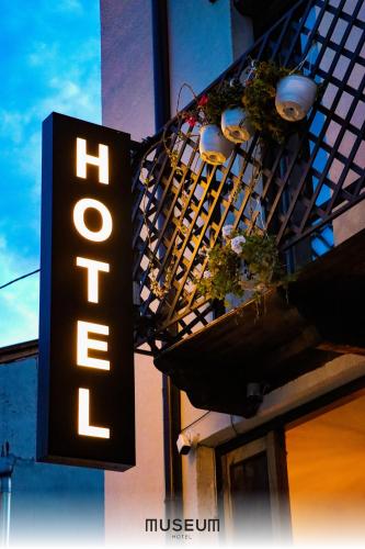 a hotel sign on the side of a building at Museum Hotel in Pristina