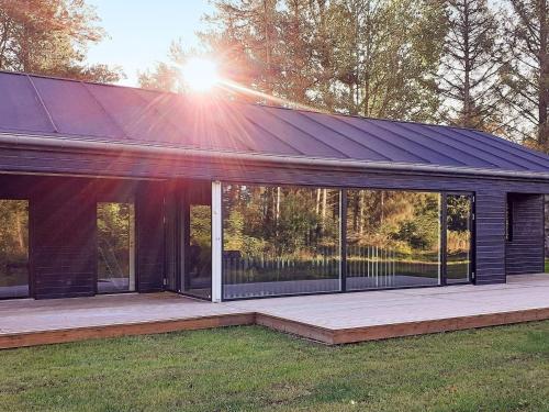 a house with a solar roof on a deck at 6 person holiday home in Hjørring-By Traum in Lønstrup