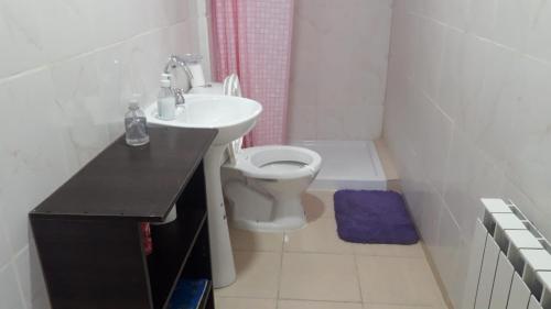 a white bathroom with a sink and a toilet at MyR alojamiento in Ushuaia