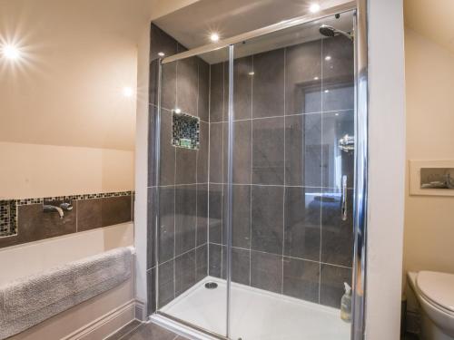 a bathroom with a shower and a toilet at The Cart Lodge in Ipswich