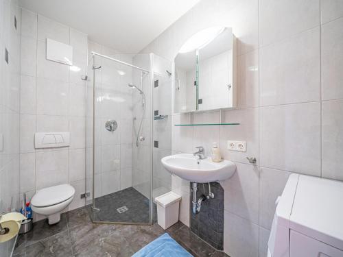 a bathroom with a shower and a toilet and a sink at Haus Sarah in Hopfgarten im Brixental