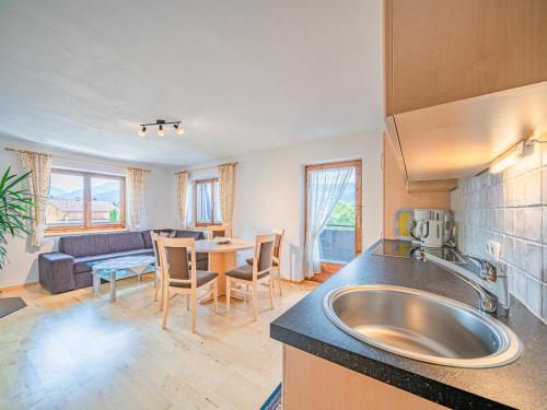 a kitchen with a sink and a living room at Chalet Josef in Westendorf