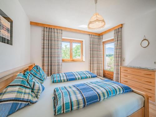 a bedroom with two beds and a television at Haus Steger in Westendorf