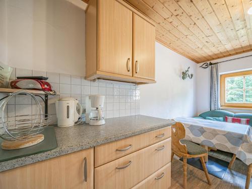 a kitchen with wooden cabinets and a table in a room at Weberhof Top 1 in Brixen im Thale