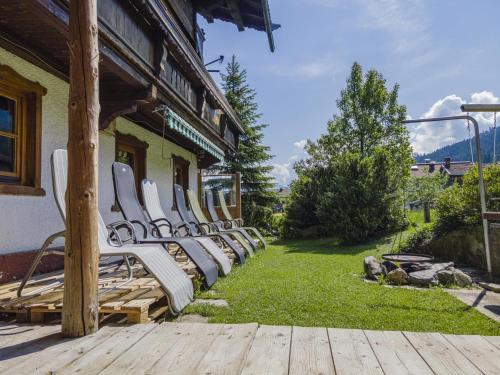 a row of white chairs sitting outside of a building at Weberhof Top 1 in Brixen im Thale