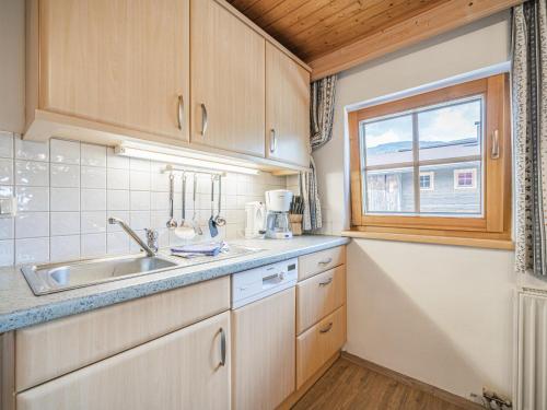 eine Küche mit einem Waschbecken und einem Fenster in der Unterkunft Weberhof Top 2 in Brixen im Thale
