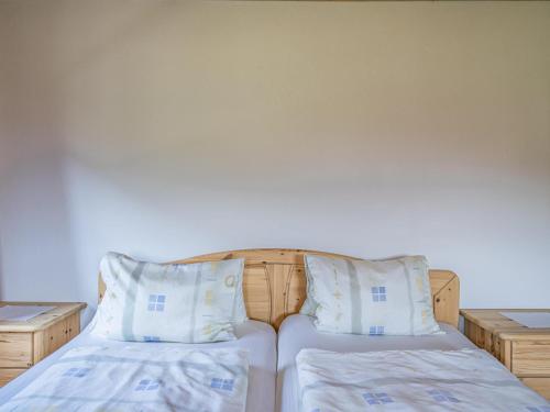 a bedroom with two beds with white sheets and pillows at Weberhof Top 2 in Brixen im Thale