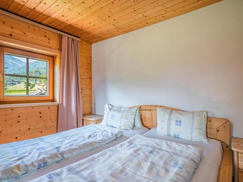 a bedroom with a bed and a window at Weberhof Top 1-2 in Brixen im Thale