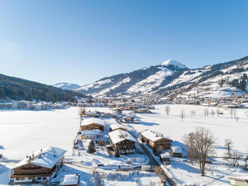 a village covered in snow with mountains in the background at Weberhof Top 1-2 in Brixen im Thale