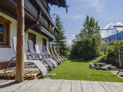 a row of white chairs sitting outside of a building at Weberhof Top 1-2 in Brixen im Thale