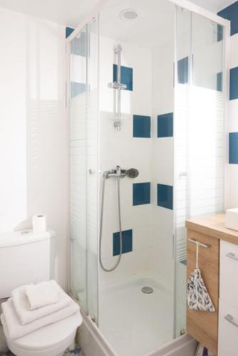 uma casa de banho com um chuveiro, um WC e um lavatório. em Spacious studio in the center of Montmartre em Paris