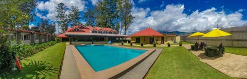 a swimming pool in the yard of a house at Highlander Hotel in Mount Hagen