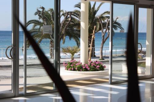 a view of the beach from the lobby of a resort at Aegean Blue Beach Hotel in Nea Kalikratia