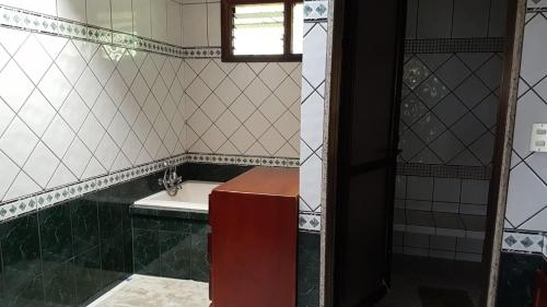 a bathroom with a sink and a toilet and a window at Villa Azul 