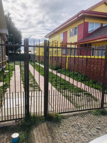 a metal fence in front of a house at Cabañas Carrera in Punta Arenas