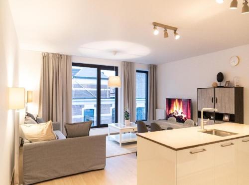 a living room with a couch and a fireplace at OneLuxStay near Diamond District in Antwerp