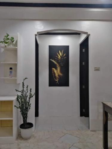 a hallway with a framed picture on a white wall at JML homestay in General Luna