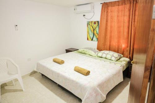 1 dormitorio con 1 cama con 2 almohadas en Ohana Lodging, en San Andrés