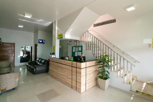 a lobby with a reception desk and a staircase at Hotel Verde Mares in Macapá