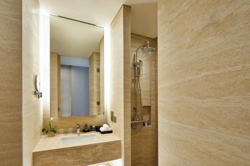 a bathroom with a sink and a shower at Shinhwa Jeju Shinhwa World Hotels in Seogwipo