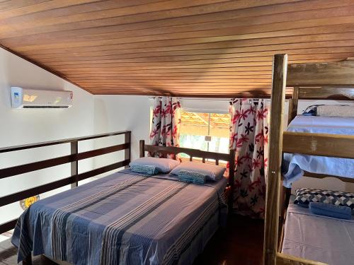 1 dormitorio con 2 literas y techo de madera en Flat Casagrande, en Morro de São Paulo