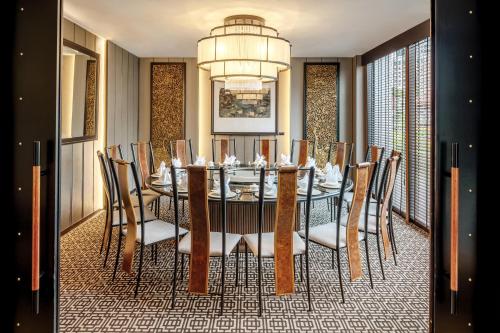 a dining room with a table and chairs at PARKROYAL on Beach Road, Singapore in Singapore