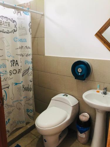 a bathroom with a toilet and a sink at EL JARDIN OLON SUITES in Olón