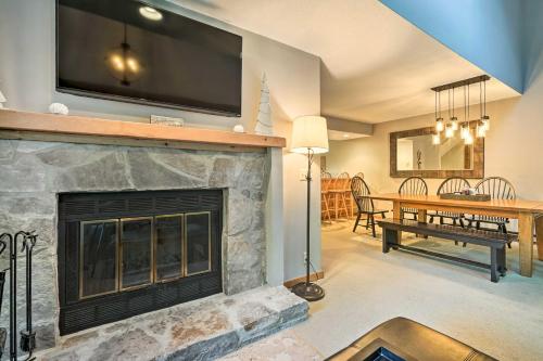 a living room with a fireplace with a flat screen tv at Family-Friendly Stratton Gem Close to Slopes! in Stratton