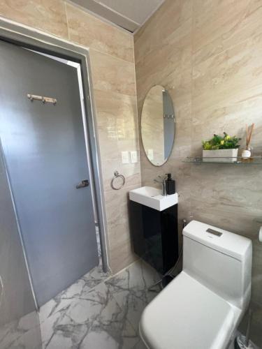 a bathroom with a toilet and a sink and a shower at Acogedor apartamento 2 hab Distrito nacional, próximo agora mall in Santo Domingo