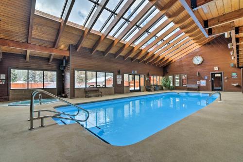 a large swimming pool in a building with a ceiling at Walkable Frisco Condo Mtn Views and Shared Hot Tub! in Frisco