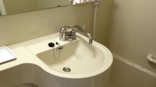 a white sink in a bathroom with a mirror at Toyoko Inn Nagoya Sakae in Nagoya