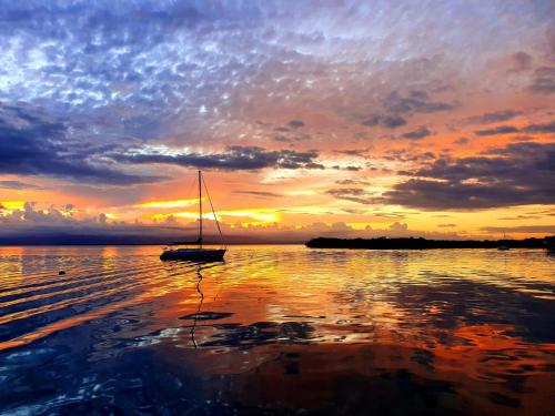 a sail boat in the water at sunset at Santuarios del Mar in Bocas del Toro