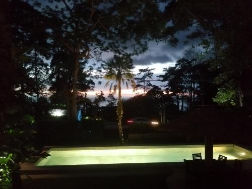 a night view of a swimming pool in a yard at Lazy Republique in Ko Chang