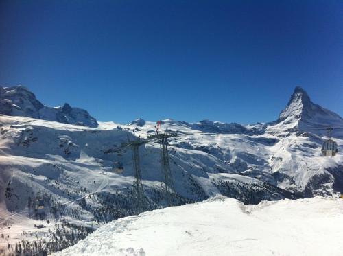 a ski lift in the snow with a mountain in the background at Hotel Adonis in Zermatt