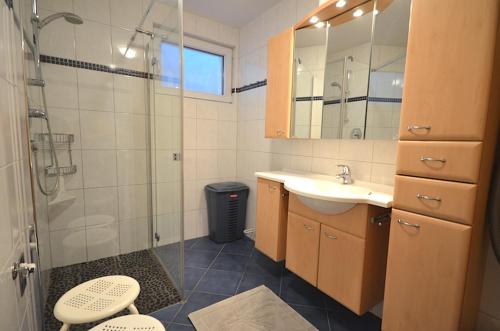 a bathroom with a glass shower and a sink at Haus Sonnplatzl in Kirchberg in Tirol