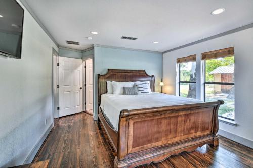 een slaapkamer met een houten bed en een raam bij Spacious Glen Rose Home on Paluxy Riverfront in Glen Rose